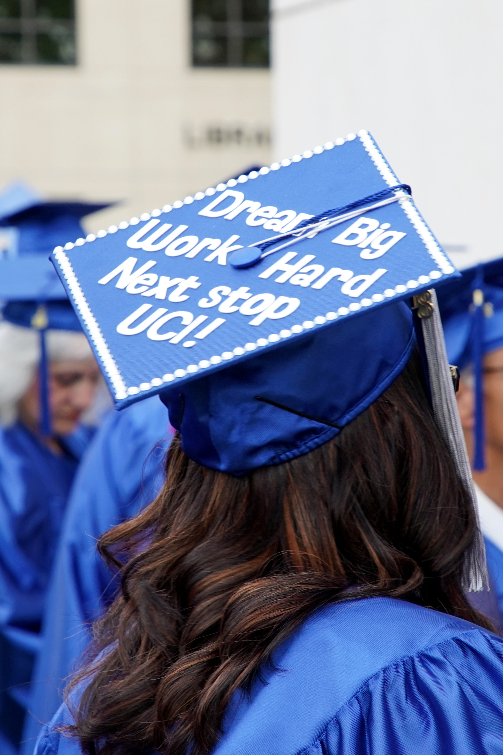 Photo of IVC graduate with mortarboard about transferring to UCI