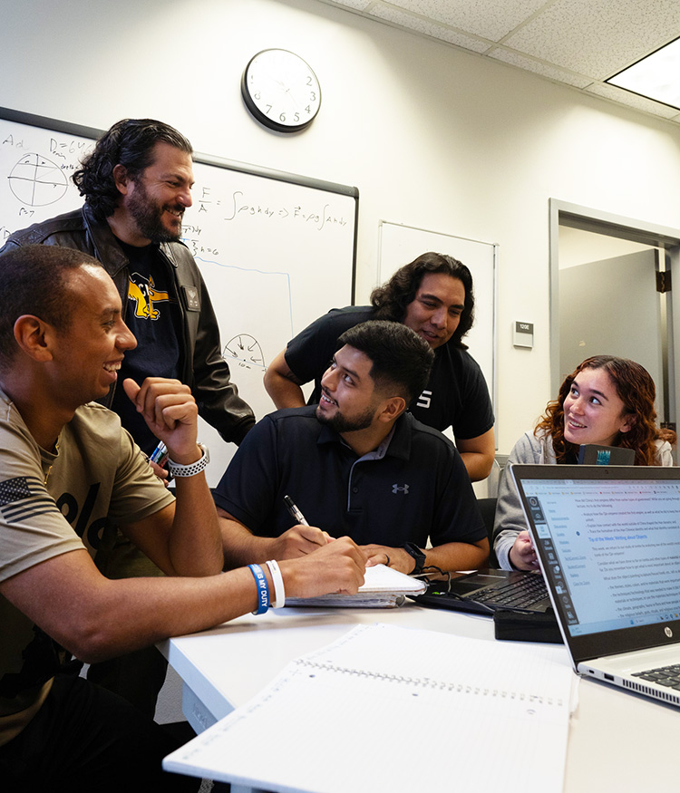 Veterans students gathered at desk 